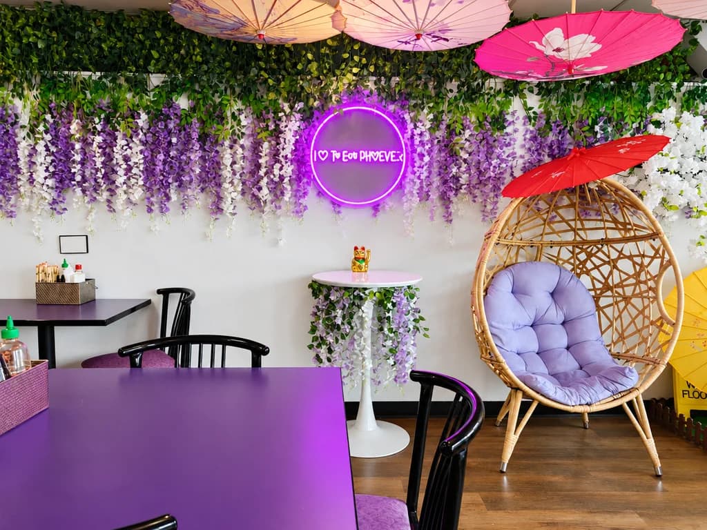 A table beneath hanging wisteria and parasols in the Phoever dining room